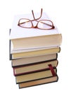 Books pile with glasses on top
