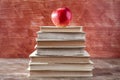 Books pyramid with red apple Royalty Free Stock Photo