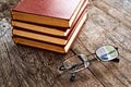 Books and reading glasses on table Royalty Free Stock Photo