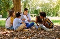 Books, reading or teacher with children in a park storytelling for learning development or growth. Smile, tree or happy Royalty Free Stock Photo