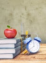 Books with red apple and blue clock Royalty Free Stock Photo