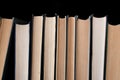 Books in a row on a black background
