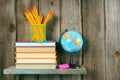 Books and school tools on a wooden shelf. Royalty Free Stock Photo