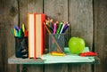 Books and school tools on a wooden shelf. Royalty Free Stock Photo