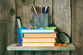 Books and school tools on a wooden shelf. Royalty Free Stock Photo