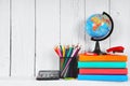 Books and school tools on a wooden shelf. Royalty Free Stock Photo