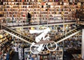 Books on shelves of popular bookstore with buyers, arts and modern decorations