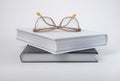 Books stack with eyeglasses. Education concept. Encyclopedia, bible, code or classics novel on grey background. Royalty Free Stock Photo