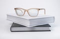 Books stack with eyeglasses. Encyclopedia, bible, code or novel on grey background. Reading and getting knowledge