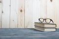 Books stacked on wooden desk in university Royalty Free Stock Photo