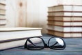 Books stacked on wooden desk in university Royalty Free Stock Photo