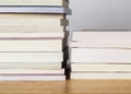 Books stacked on a wooden table.