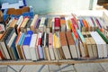 Books stand piled next to each other for sale