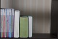 Books stand on a shelf in the library