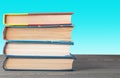 Books on a table on a green background