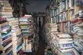 Books in used reading material store, chaotic stacks Royalty Free Stock Photo
