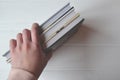 Books in the woman hand on the white background. Royalty Free Stock Photo