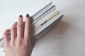 Books in the woman hand on the white background. Royalty Free Stock Photo