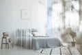 Books on wooden table in bright bedroom interior with patterned Royalty Free Stock Photo