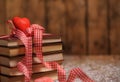 Books wrapped with color ribbon, on wooden table