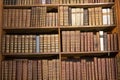 Bookshelf with antique old books in the museum library Royalty Free Stock Photo