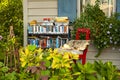 A bookshelf full of books of different genre left outside for people to use