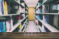 bookshelf in library with many books, blur background with selective focus wood table for display your product Royalty Free Stock Photo