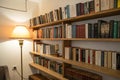 Bookshelf on the wall with lamp and books Royalty Free Stock Photo