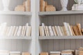 Bookshelf is white book with wooden white shelf.