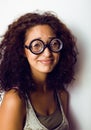 Bookworm, cute young woman in glasses, curly hair, teenage Royalty Free Stock Photo