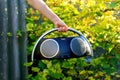 Boombox. Defocus hand holding retro music recorder on nature. Retro outdated portable stereo boombox radio receiver with