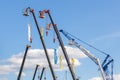 Booms of cranes and telescopic lifting cradles at the construction industry fair Bauma CCT Russia. Moscow, Russia - May