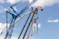 Booms of cranes and telescopic lifting cradles at the construction industry fair Bauma CTT Russia. Moscow, Russia - May