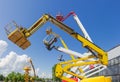 Booms and top parts of different articulated boom lifts Royalty Free Stock Photo