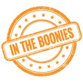 IN THE BOONIES text on orange grungy round rubber stamp