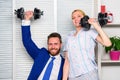 Boost sales with strong strategy. Good job concept. Boss businessman and office manager raise hand with dumbbells. Boost Royalty Free Stock Photo