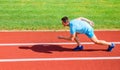 Boost speed concept. Man athlete runner push off starting position stadium path sunny day. Runner sprint race at stadium