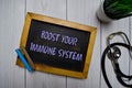 Boost Your Immune System write on a chalkboard isolated on office desk