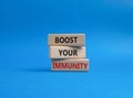 Boost your immunity symbol. Concept word Boost your immunity on wooden blocks. Beautiful blue background. Helthcare and Boost your