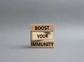 Boost your immunity symbol. Concept word Boost your immunity on wooden blocks. Beautiful grey background. Helthcare and Boost your