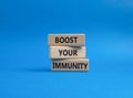 Boost your immunity symbol. Concept word Boost your immunity on wooden blocks. Beautiful blue background. Helthcare and Boost your