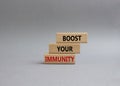 Boost your immunity symbol. Concept word Boost your immunity on wooden blocks. Beautiful grey background. Helthcare and Boost your