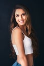 Boost your self confidence with a smile. Studio portrait of an attractive young woman posing against a dark background. Royalty Free Stock Photo