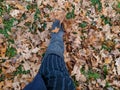 Boot kicking autumn leaves