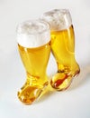 Boot shaped beer glasses filled with frothy lager Royalty Free Stock Photo