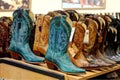 Colorful designer boots on display in a retail store.