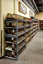 Rows of cowboy boots on shelves in a Boot Barn store.