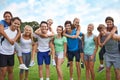 Bootcamp buddies. A group of young men giving their female team mates a piggyback ride on a sportsfield. Royalty Free Stock Photo