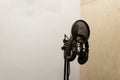 A booth for recording sound. Microphone and headphones for recording. Listening and recording