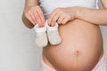 Booties for newborn in the hands of a pregnant girl Royalty Free Stock Photo